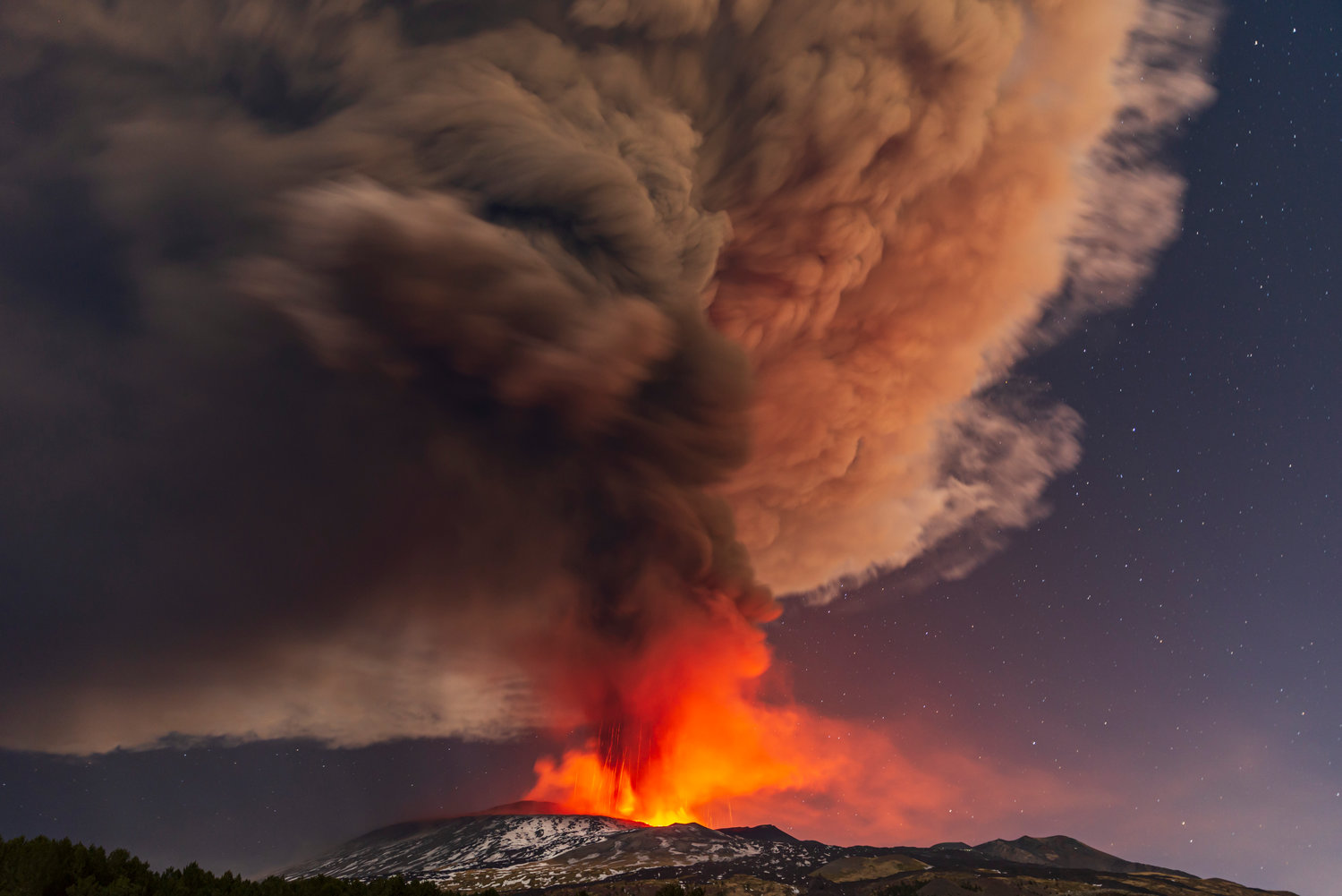 Smoke billows from the Mt. Etna volcano, as seen from Nicolosi, Sicily, southern Italy, Thursday, Feb. 10, 2022. (AP Photo/Salvatore Allegra)